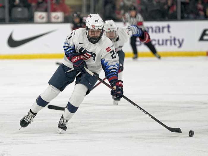 Nov 21, 2021; Kingston, Ontario, CAN; USA forward Britta Curl (27) tries to control a puck against Canada during the first period in a Rivalry Series women's hockey game at Leon's Centre. Mandatory Credit: John E. Sokolowski-USA TODAY Sports